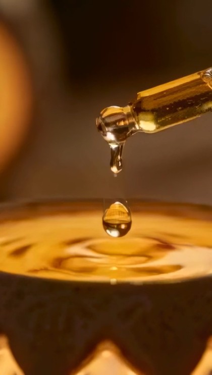 A drop of serum falling from a dropper